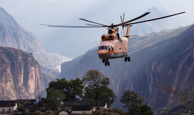 Mi-26 heavy transport helicopter used to help transport machinery for road contruction