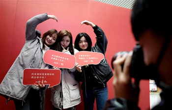 Passengers have photos taken in Jinan West Railway Station